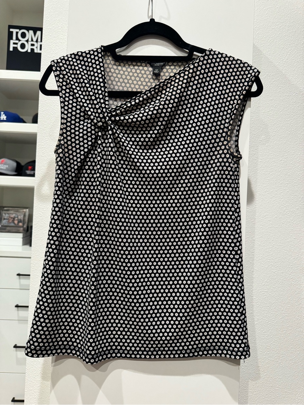 Ann Taylor sleeveless top features a distinctive black and white polka doat